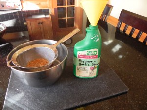 Strain pepper mixture and put in spray bottle.